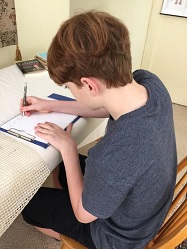 Boy writing before lessons